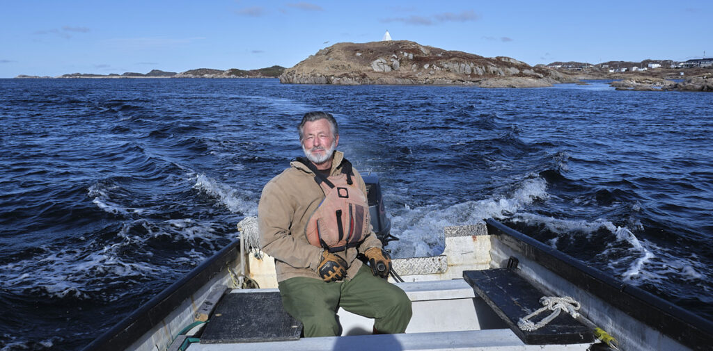 Durham Keeping navigates his boat around Eclipse Island near Burgeo, Newfoundland, Canada. Photo by Greg Locke. Copyright 2024